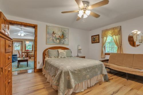 a bedroom with a bed and a ceiling fan at Cozy Bungalow Just Minutes from Mystic, Westerly Beaches, Boating and Casinos! bungalow in Groton