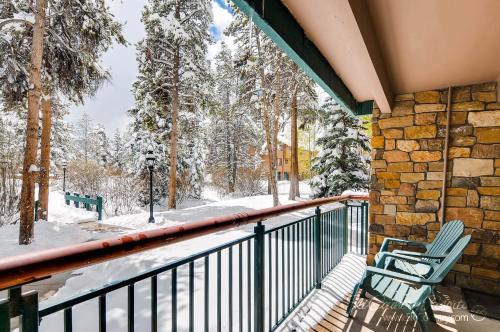 - un balcon avec 2 chaises et des arbres enneigés dans l'établissement Rustic Charm Meets Comfort, Homey and Affordable with Scenic Mountain Views TE112, à Breckenridge