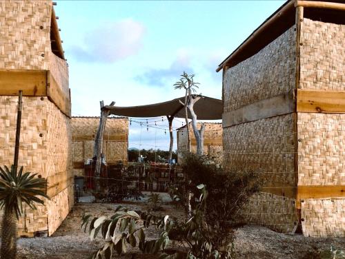 a brick building with a patio with a table and chairs at Sunset Paradise - Todos Santos in Todos Santos