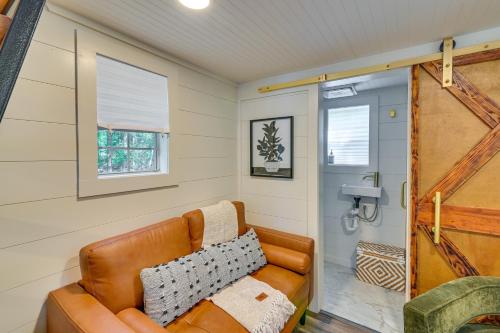 - un salon avec un canapé en cuir et une fenêtre dans l'établissement Contemporary Starkville Tiny Cabin 3 Mi to MSU!, à Starkville
