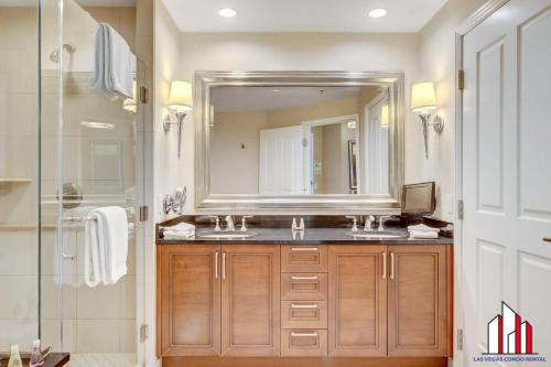 a bathroom with a sink and a mirror at MGM Signature-27-805 F1 Track & Strip View Balcony in Las Vegas