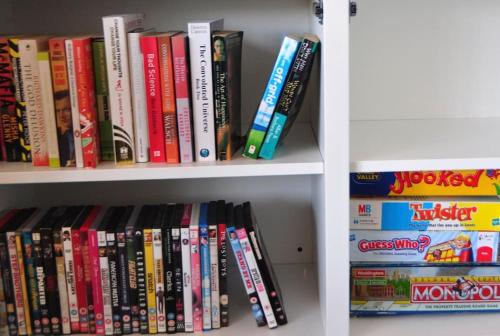 a book shelf filled with lots of books at Luxury house in The New Forest in Sway