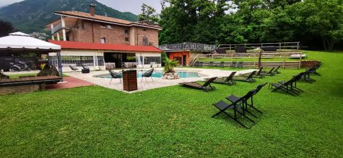 a group of benches sitting in the grass next to a building at Country House in Mercogliano