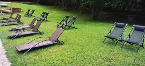a group of lawn chairs sitting in the grass at Country House in Mercogliano