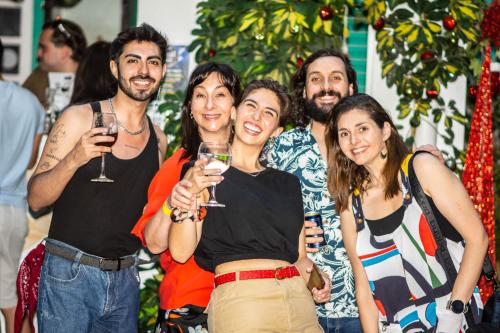 a group of people posing for a picture with wine glasses at Hostal Providencia in Santiago
