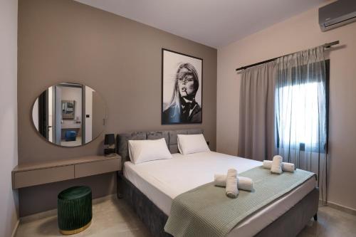a bedroom with a large bed and a mirror at Maison 4 Seasons in Kalamata