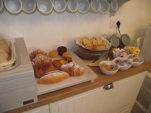 a counter with various types of pastries and other foods at Mediterranea Sea House in Montesilvano