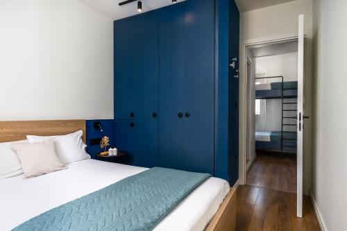 een slaapkamer met een blauwe muur naast een bed bij Corfu Lux City in Ágios Rókkos