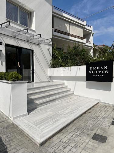 a white building with a sign in front of itani studios at URBAN SUITES ATHENS in Athens