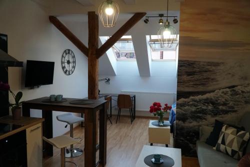 a living room with a desk and a table at Apartament w centrum OSTOYA 1 in Ełk