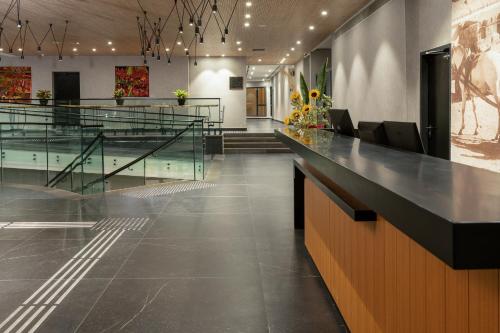 a lobby with a swimming pool and a reception desk at Kfar Giladi Hotel in Kefar Gil‘adi