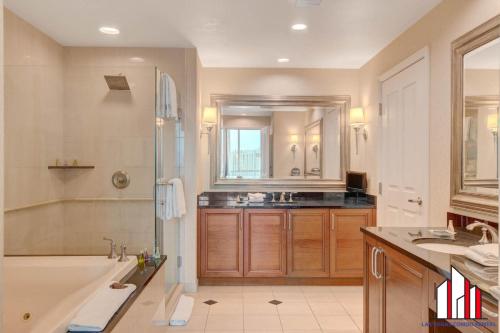 a bathroom with a tub and a shower and a sink at MGM Signature-32-621 1Br2Ba F1 Strip View Balcony in Las Vegas