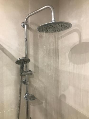 a shower with a shower head in a bathroom at Koroni House in Heraklio Town