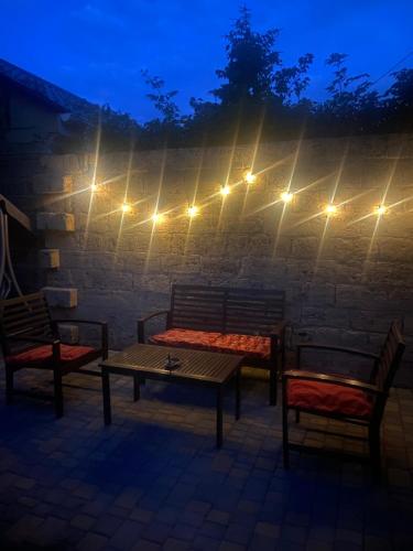 a patio with two chairs and a table and lights at Дом для отдыха на Фонтане in Odesa