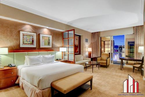 a bedroom with a large bed and a living room at MGM Signature-33-705 F1 Track & Strip View Balcony in Las Vegas