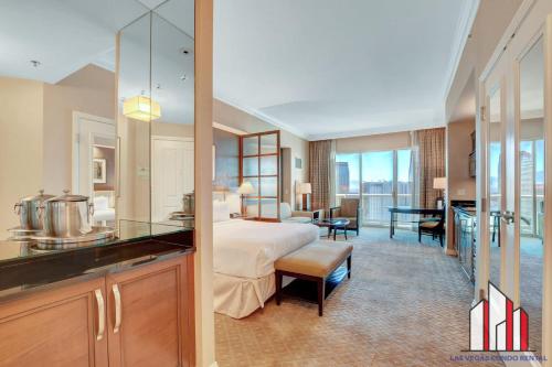 a hotel room with a bed and a kitchen at MGM Signature-33-705 F1 Track & Strip View Balcony in Las Vegas
