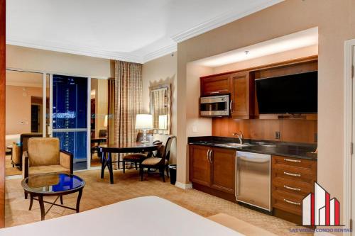 a room with a kitchen and a living room at MGM Signature-33-705 F1 Track & Strip View Balcony in Las Vegas