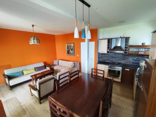 a kitchen and a living room with orange walls at Villa Paradiso in Ohrid