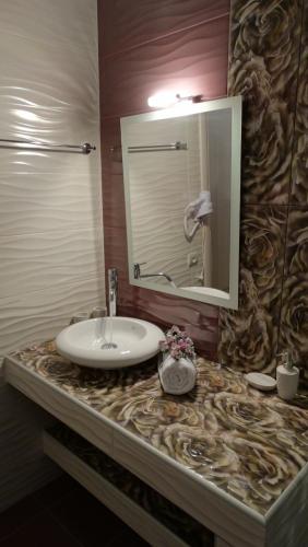 a bathroom counter with a sink and a mirror at Villa Maria PF in Nydri