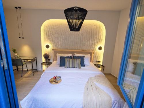 a bedroom with a large bed with a white bedspread at Il Porto Blu in Chania Town