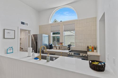 a kitchen with a sink and a large window at Stylish Phoenix Townhome - Central Location & Sleeps 8 in Phoenix