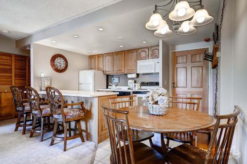 a kitchen and dining room with a table and chairs at RECENTLY UPDATED Ski In & Out Condo with Heated Garage Parking and VIEWS! TE303 in Breckenridge
