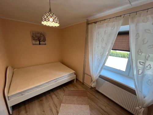 a small bedroom with a bed and a window at Lovely and cozy apartment in central Tartu in Tartu