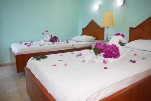 duas camas com flores em cima em Ares City Hotel em Kemer