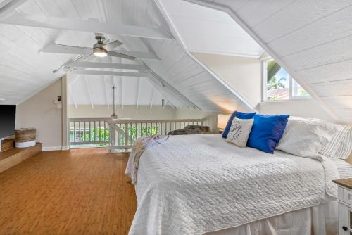 a bedroom with a bed with blue and white pillows at 3982S Kalakaua Gorgeous Princevile Studio in Princeville