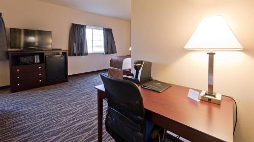 a hotel room with a desk with a computer and a lamp at Cobblestone Inn & Suites - Boone in Boone