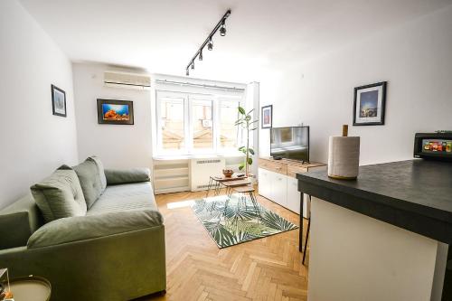 a living room with a couch and a television at Apartment Petra 073 in Belgrade