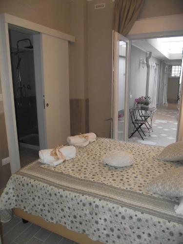 a bedroom with a large bed with towels on it at Mediterranea Sea House in Montesilvano