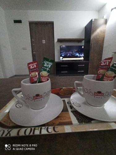 two cups of coffee on a table in a living room at Apartmani Kula in Tuzla