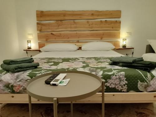 a bed with a table with a remote control on it at CasaRA in Bari