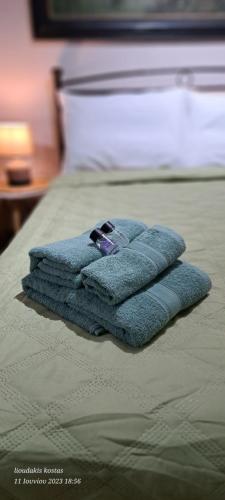 a pile of towels sitting on top of a bed at Zoe garden home in Spáta