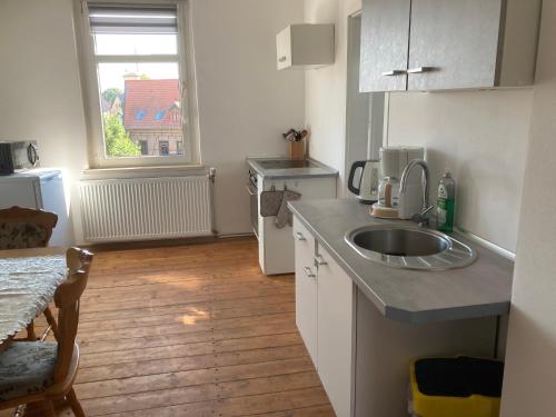 a small kitchen with a sink and a window at P7 gemütliche Ferienwohnung 
