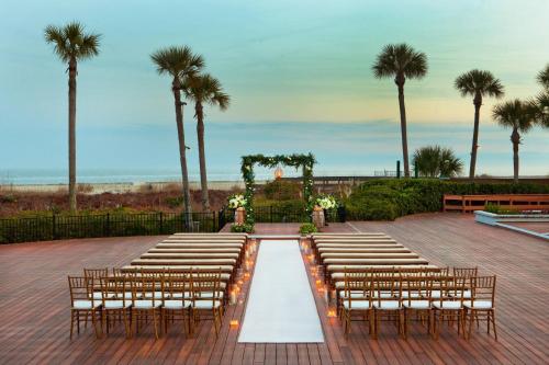 a row of chairs and a altar with palm trees at The Westin Hilton Head Island Resort & Spa in Hilton Head Island
