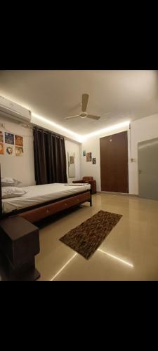 a bedroom with a bed and a ceiling fan at Panah . in Guwahati