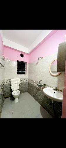 a bathroom with a toilet and a sink at Panah . in Guwahati