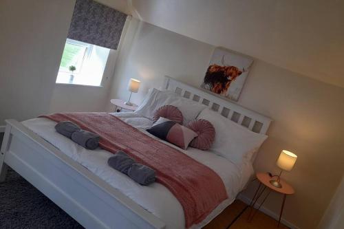 a bedroom with a large bed with pillows on it at Emma's Cottage in Brookeborough