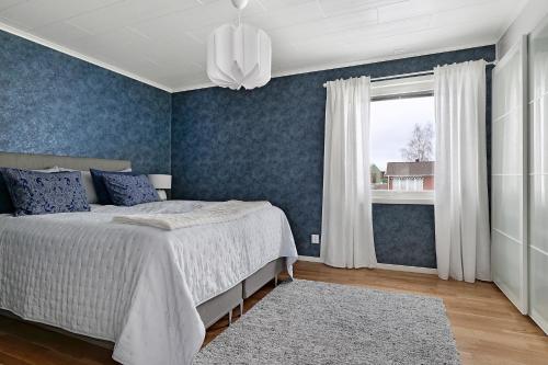 a bedroom with a bed and a window at Guestly Homes - 3BR Business Getaway with Sauna in Boden