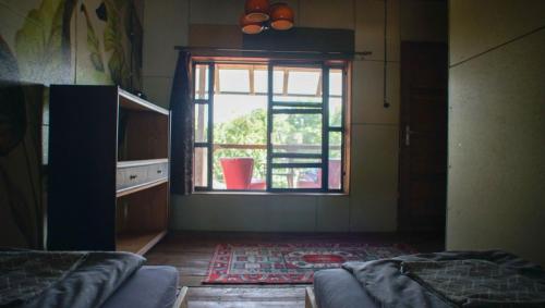 a living room with a window and a couch and a rug at Sárgarigó Élményház in Szeged