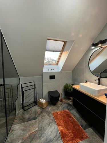 a bathroom with a sink and a mirror at Modern Village in Nowinka