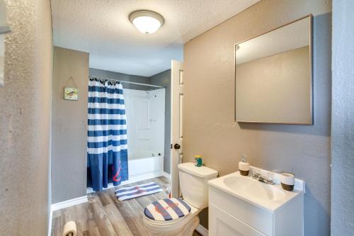 a bathroom with a sink and a toilet and a mirror at Pet-Friendly Texas Escape with Deck and Fenced-In Yard in Freeport