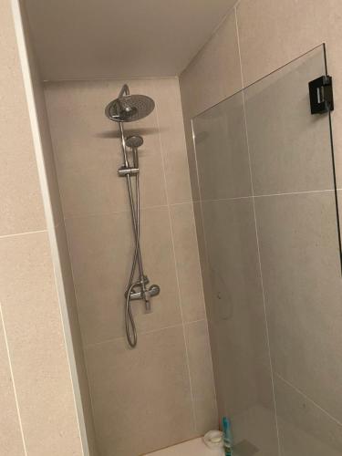 a shower with a shower head in a bathroom at Kobé Place in Barcelona
