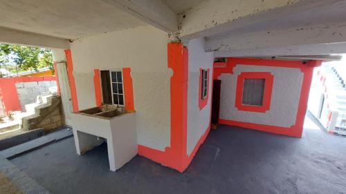a room with a red and white house on the floor at Lovely 2 Bedroom House in St Thomas Jamaica in Belfast