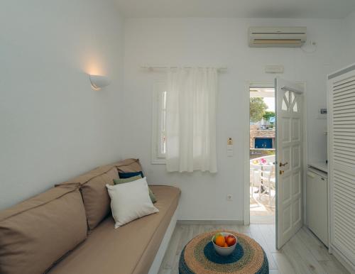 a living room with a couch and a table at Nostos Sifnos in Apollonia