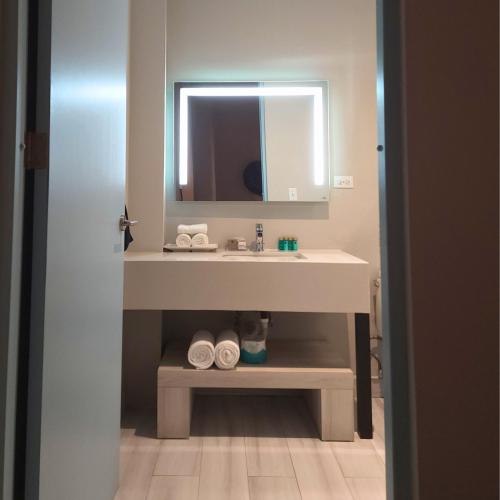 a bathroom with a sink and a mirror at Trópica Beach Hotel in San Juan