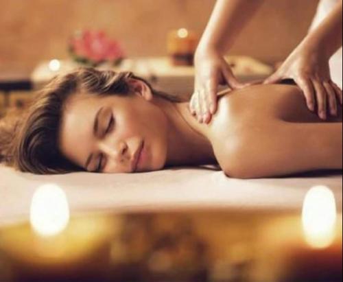a woman getting a massage in a hot tub at EM apartments in Ulcinj