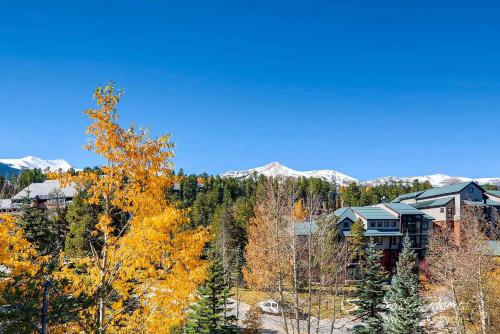 a house in the middle of a forest with mountains at Ideal Breck Location, Downtown, Mountain Views, Wi-Fi, Garage Parking TE405 in Breckenridge